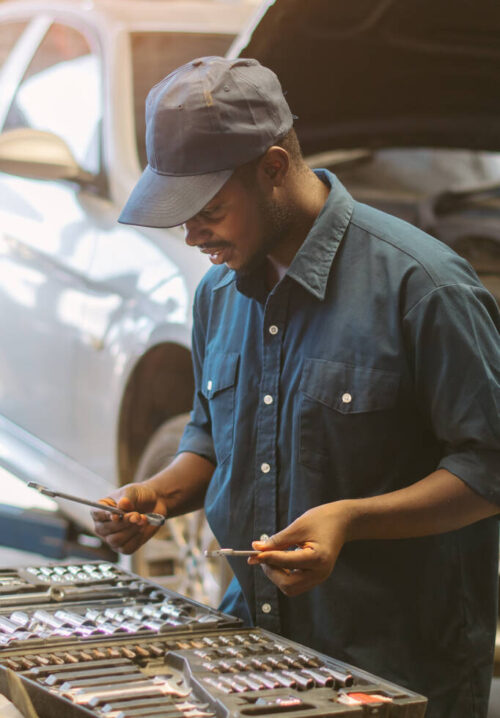African maintenance male  are choosing tools to repair the car