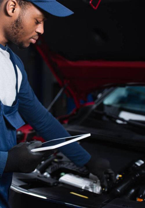 stock-photo-young-african-american-repairman-holding-digital-tablet-while-making-inspection